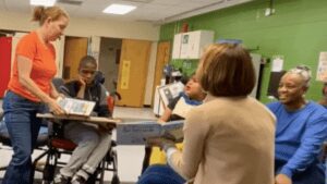 Two teachers at The Carter School read to students in a special education classroom.