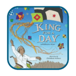 King for a Day Book Cover - Building Wings Blue background with a dark-skinned boy wearing a white shirt in a wheelchair holding multiple multicolored kites with the book title - King for a Day by Rukhsana Khan.