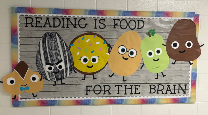 School bulletin board in a hallway titled Reading is food for the brain.
